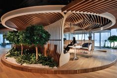 an office with wood and plants in the center