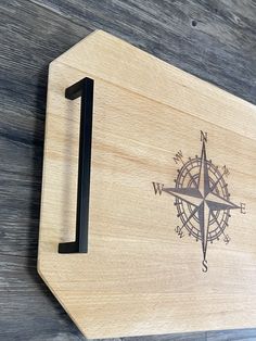 a wooden sign with a compass on it and the number one in front of it