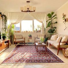 a living room filled with furniture and plants