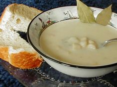 a close up of a bowl of soup with bread