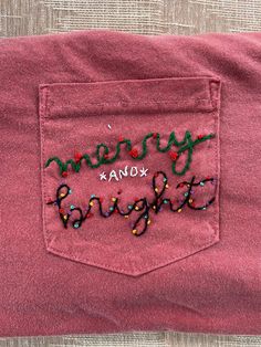 a pink shirt with the words merry xoxana embroidered on it's pocket