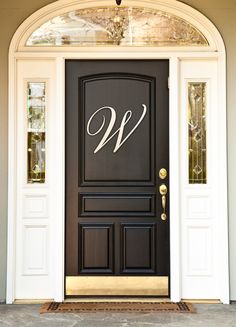 a black front door with the letter w on it