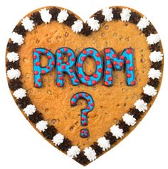 a heart shaped cookie with the word prom written in blue and white frosting on it