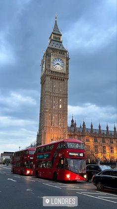 the big ben clock tower towering over the city of london, england at dusk with cars passing by