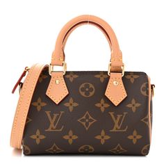 This is an authentic LOUIS VUITTON Monogram Nano Speedy Bandouliere. This bag is crafted of Louis Vuitton monogram on toile canvas. It features vachetta cowhide rolled leather top handles with small polished brass links and an optional vachetta leather crossbody shoulder strap. The top zipper opens to a cocoa fabric interior. Nano Speedy, Louis Vuitton Crossbody Bag, Speedy Bandouliere, Louis Vuitton Crossbody, Polished Brass, Leather Top, Authentic Louis Vuitton, Leather Crossbody, Louis Vuitton Monogram