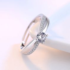 a diamond ring on top of a white plate with a napkin in front of it