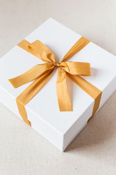 a white box with yellow ribbon on it