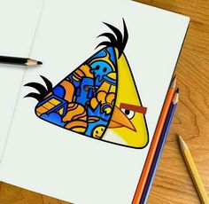 a drawing of an angry bird on paper next to colored pencils