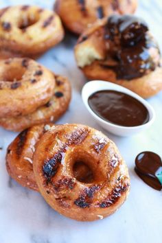 several donuts with chocolate sauce on them