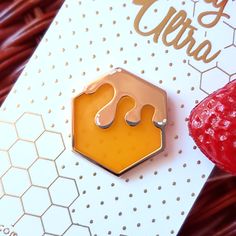 A simple honeycomb enamel pin with translucent enamel for the "honey"! ♡ This pin measures 1 inch wide and features gold colored metal with white screen printed details Jewelry Pins