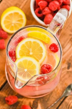 raspberry lemonade punch with fresh raspberries in the background