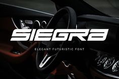 the steering wheel and dashboard of a car with white lettering that reads,'siegra elegant futuristic font