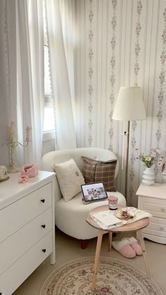 a living room with white furniture and floral wallpaper on the walls, along with a round rug