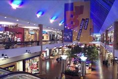 the inside of a shopping mall filled with people