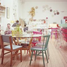 there are many chairs around the table in this room and one person is sitting at the table