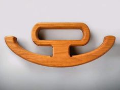 a wooden object that looks like a toothbrush holder with the letter f on it