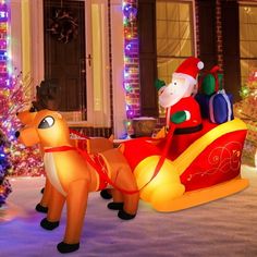 an inflatable christmas sleigh with santa claus and reindeers on it