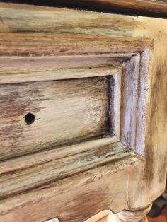 an old wooden cabinet with holes in it