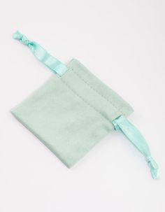 a small green bag with a blue ribbon around it