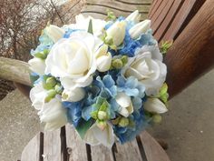 a bridal bouquet sitting on top of a wooden bench