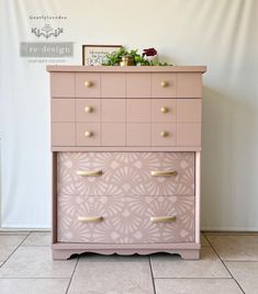 a pink dresser sitting on top of a tiled floor