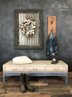 a white bench sitting in front of a painting on the wall