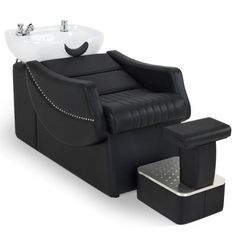 a black chair with a white sink and footstool in front of it on a white background