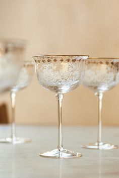 four wine glasses sitting on top of a table