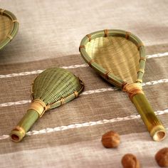 two small bamboo baskets sitting on top of a table next to nuts and other items