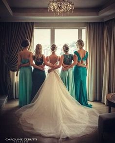 the bridesmaids are looking at each other in their wedding gowns and dresses