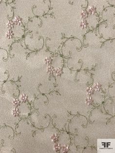 the fabric has flowers on it and is very light beige with green stems in the center