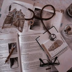 an open book with glasses and a stethoscope sitting on top of it