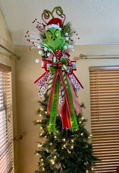 a decorated christmas tree in the corner of a room