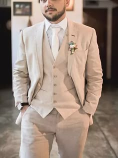 a man wearing a suit and tie standing in a room