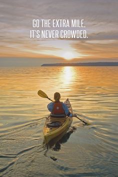 a person in a kayak on the water with a quote about going to the extra mile it's never crowded