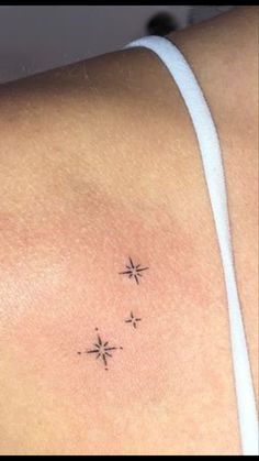 a woman's shoulder with three small stars on it