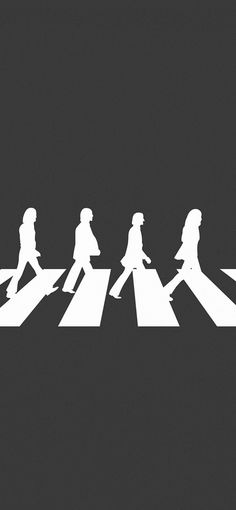 a group of people walking across a crosswalk