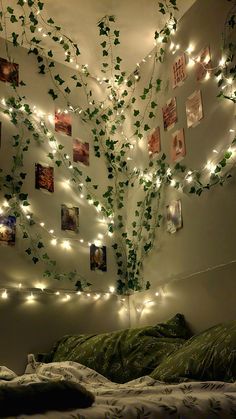 the bedroom is decorated with string lights and ivys on the wall above the bed