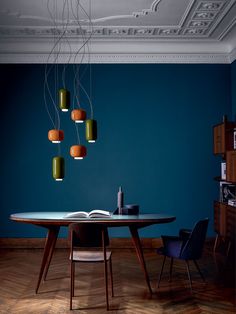 a table with some lights hanging from it and a book on the table next to it