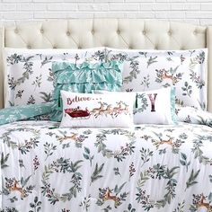 the comforter is made up with deer and berries on it, along with two pillows