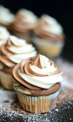 cupcakes with white frosting and chocolate icing