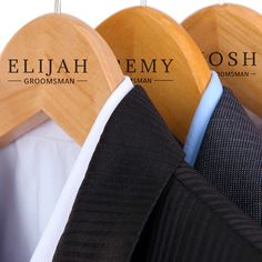 three wooden hangers displaying different types of suits