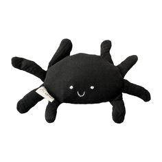 a black stuffed animal with a smile on it's face