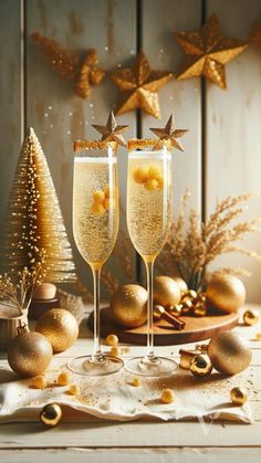 two champagne flutes with golden decorations and gold stars