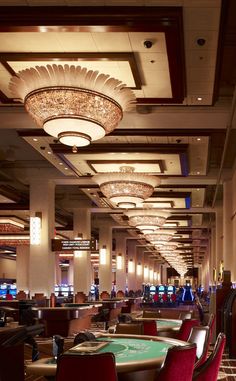 a casino room filled with lots of tables and chairs