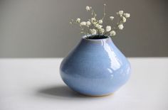 a blue vase with white flowers in it