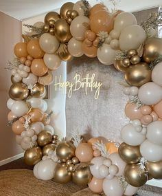 a happy birthday balloon arch with gold, white and pink balloons in the shape of a wreath