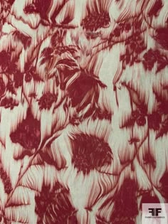 a red and white floral print fabric with large flowers on the bottom half of it