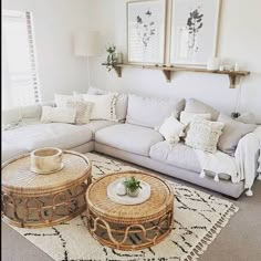 a living room filled with white furniture and lots of pillows on top of the couch