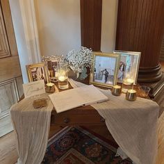 a table topped with pictures and candles on top of a rug